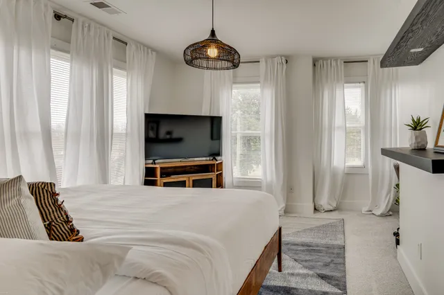 a bedroom with a bed and a television