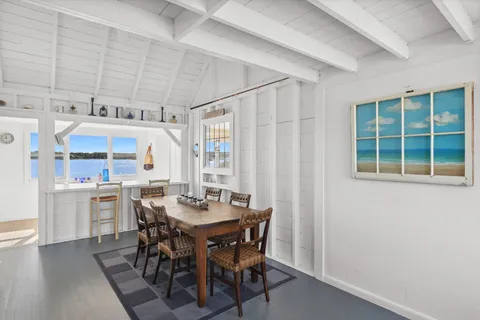 a view of a dining room with furniture and window
