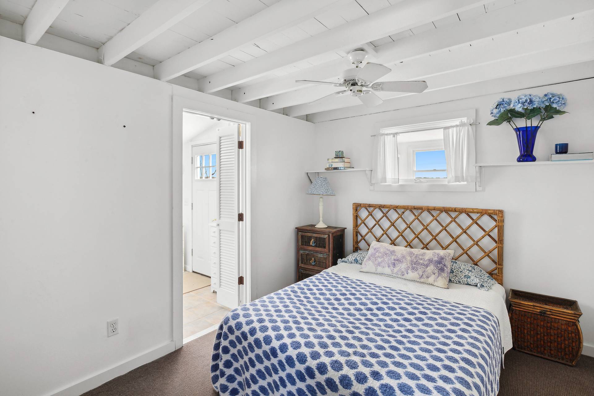 238 Towd Point Road Southampton, NY 11968 - Photo 14 of 34 a bedroom with a bed and a chandelier