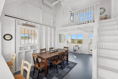 a view of a dining room with furniture and window
