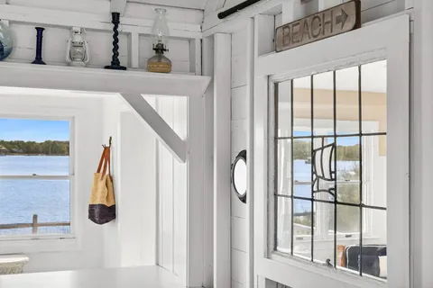 a view of walk in closet with window and chandelier