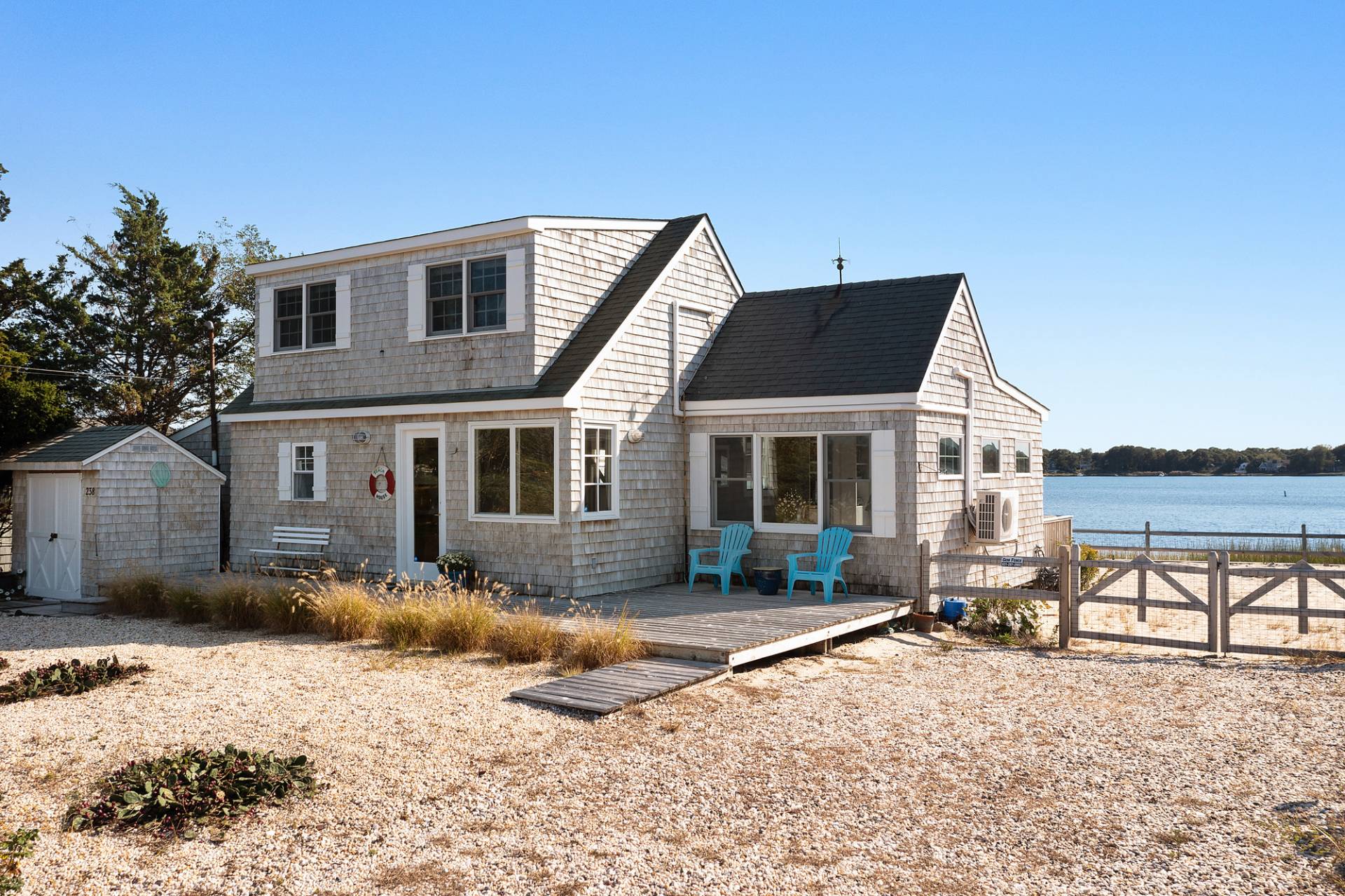238 Towd Point Road Southampton, NY 11968 - Photo 25 of 34 a front view of a house with a yard