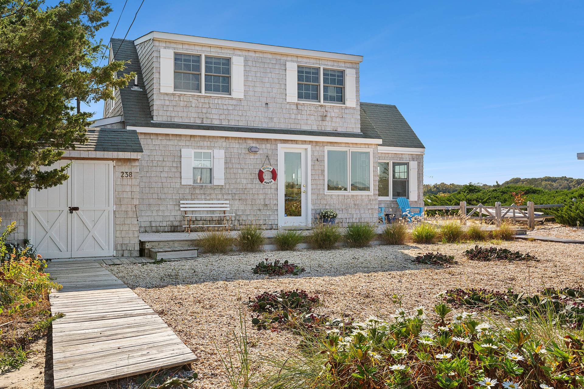 238 Towd Point Road Southampton, NY 11968 - Photo 27 of 34 a front view of a house with a yard