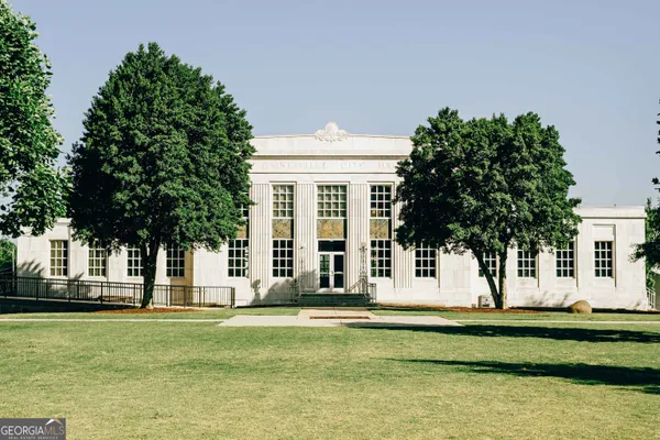 a view of a house with backyard porch and sitting area