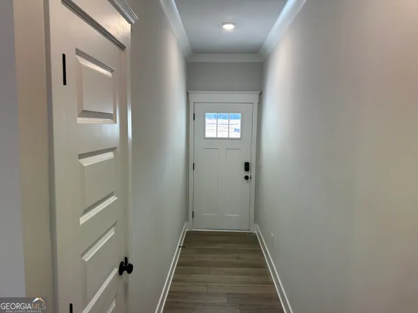 a kitchen with stainless steel appliances granite countertop a sink a stove and a wooden floors