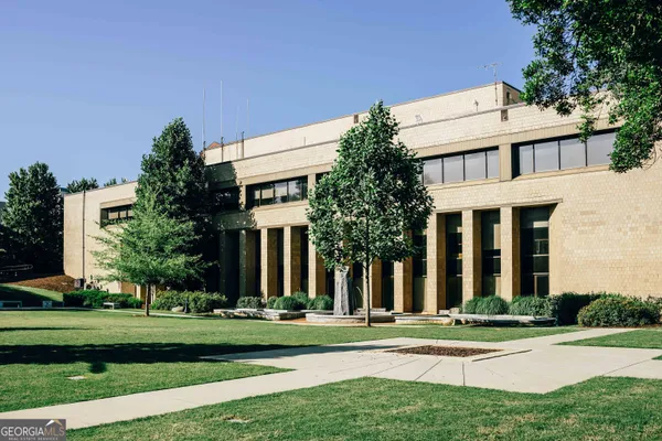 a front view of a house with garage and plants