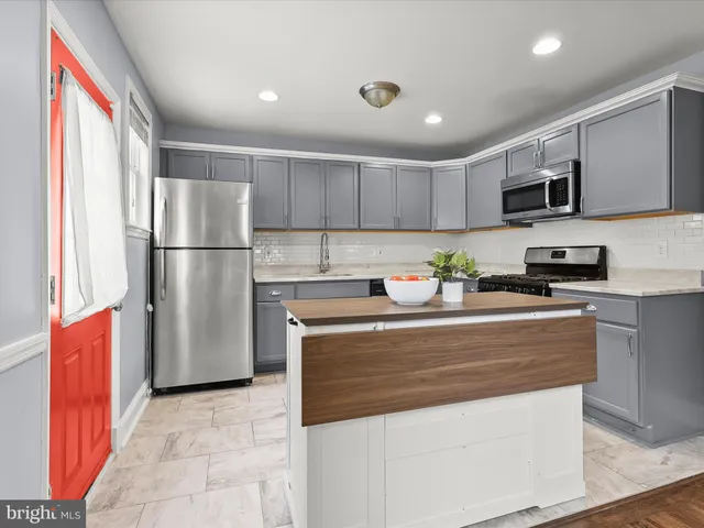 a kitchen with stainless steel appliances granite countertop a sink and cabinets