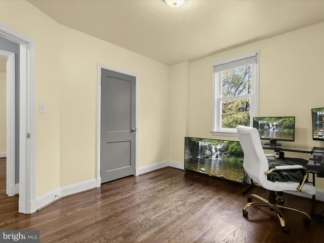 a view of a workspace with furniture and a window