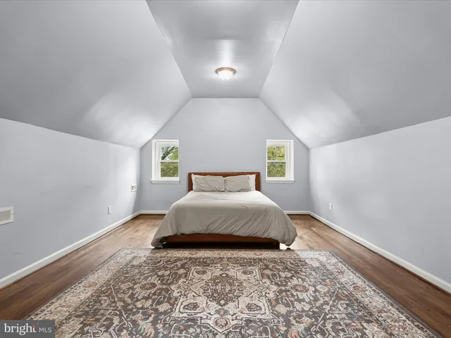 a view of a workspace with wooden floor and a window