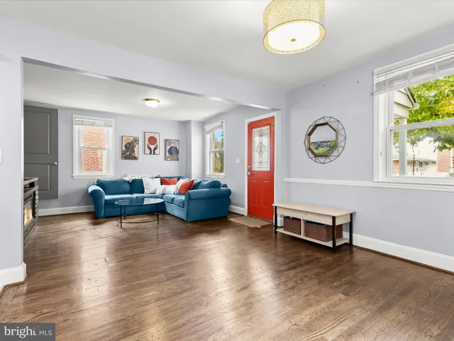 a living room with furniture window and wooden floor
