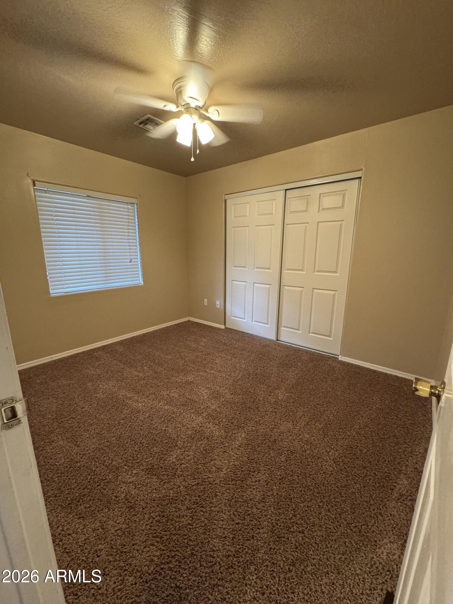 574 Walnut Creek Loop Pinetop, AZ 85935 - Photo 18 of 23 a view of an empty room with a chandelier fan