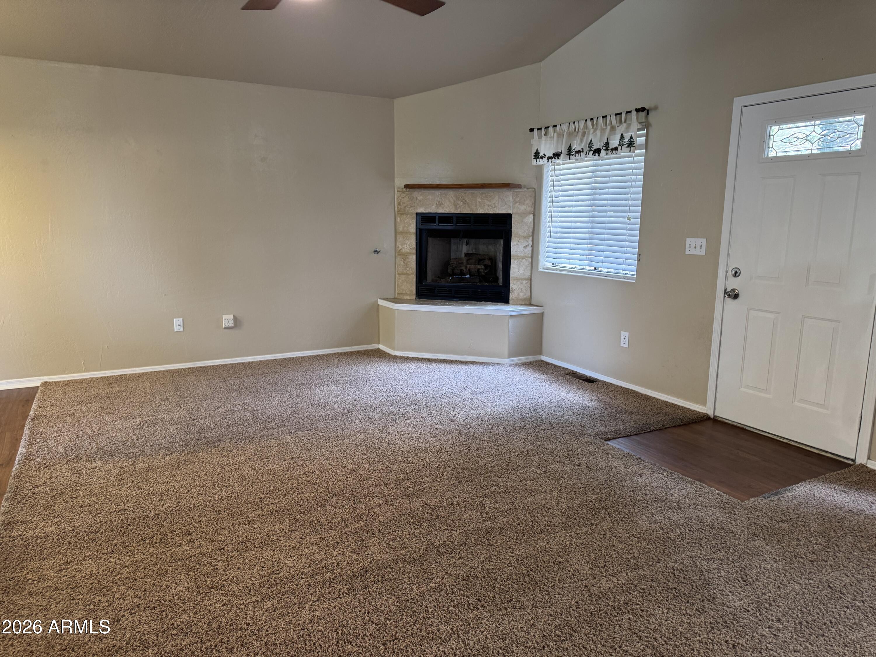 574 Walnut Creek Loop Pinetop, AZ 85935 - Photo 3 of 23 a view of an empty room with a fireplace