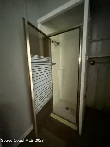 a bathroom with a glass shower door