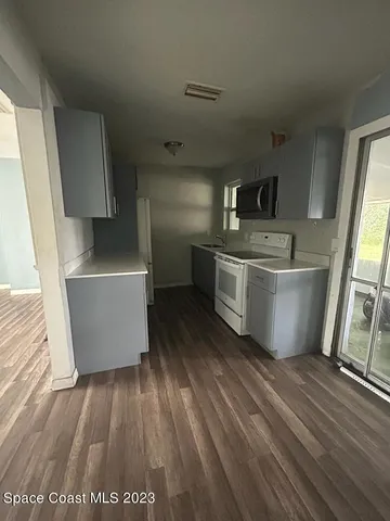 a room with wooden floor and furniture