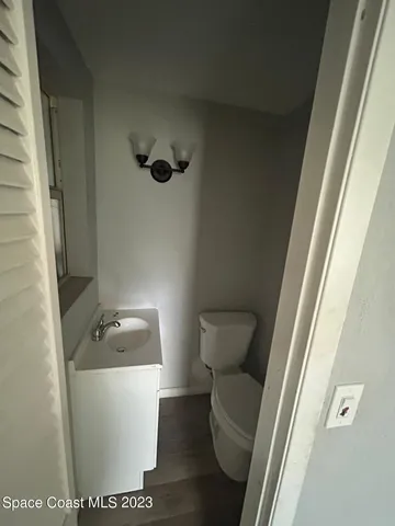 a white toilet sitting next to a sink