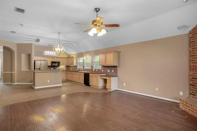 a view of a kitchen with a sink hardwood floor and a window