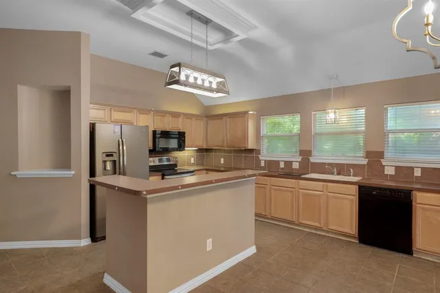 a kitchen with stainless steel appliances granite countertop a sink and cabinets