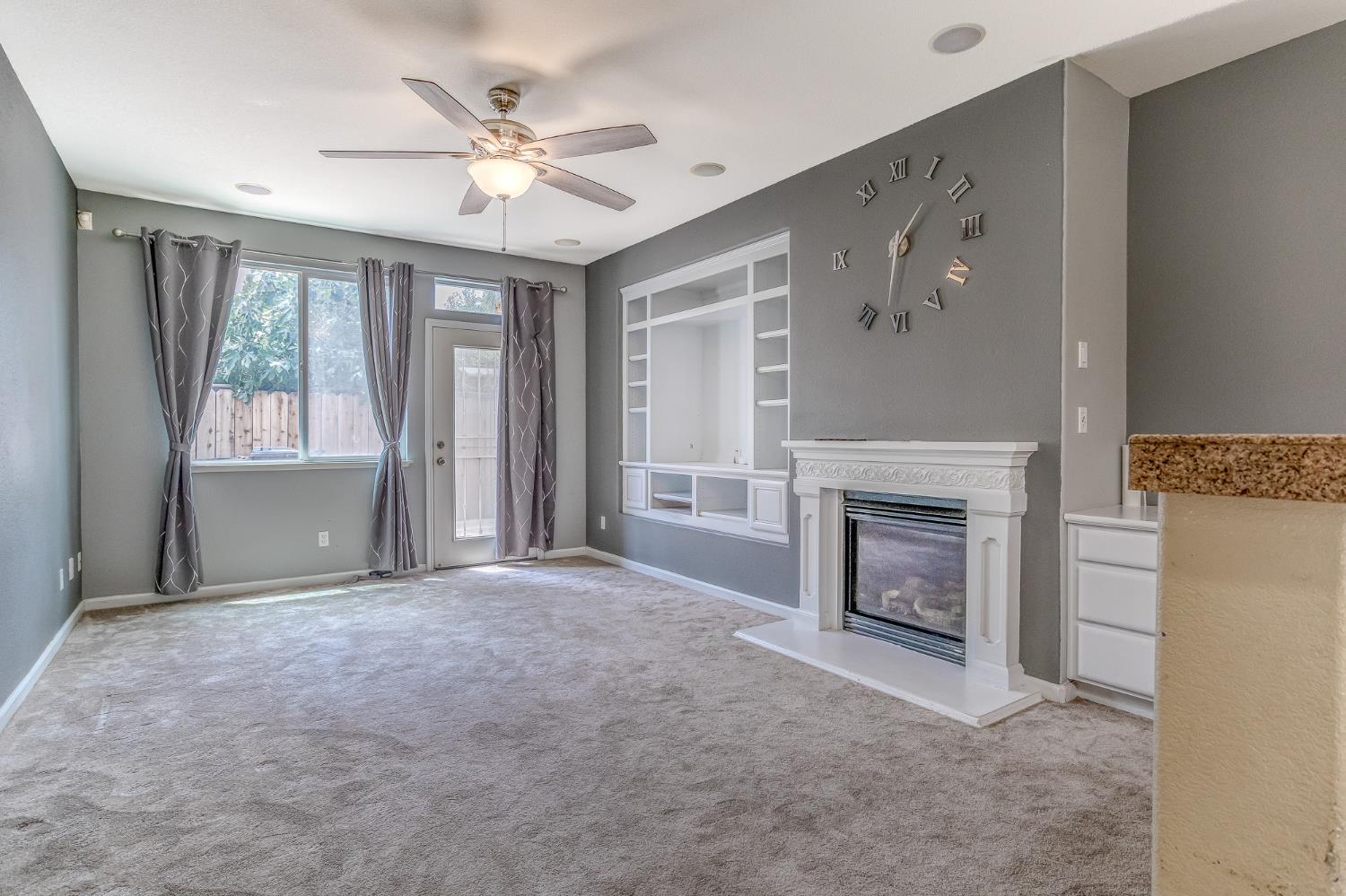 188 Thomsen Road Lathrop, CA 95330 - Photo 11 of 27 a view of an empty room with a fireplace and a window