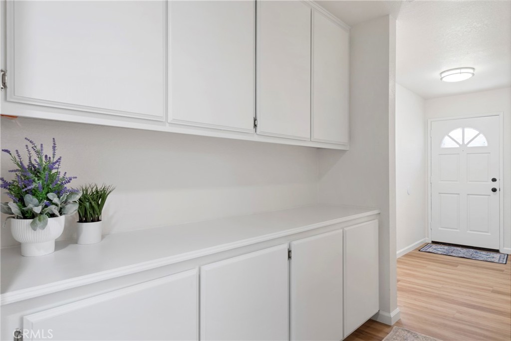 700 West 2nd Street, Unit 2 Azusa, CA 91702 - Photo 17 of 39 a white kitchen with white cabinets and a potted plant