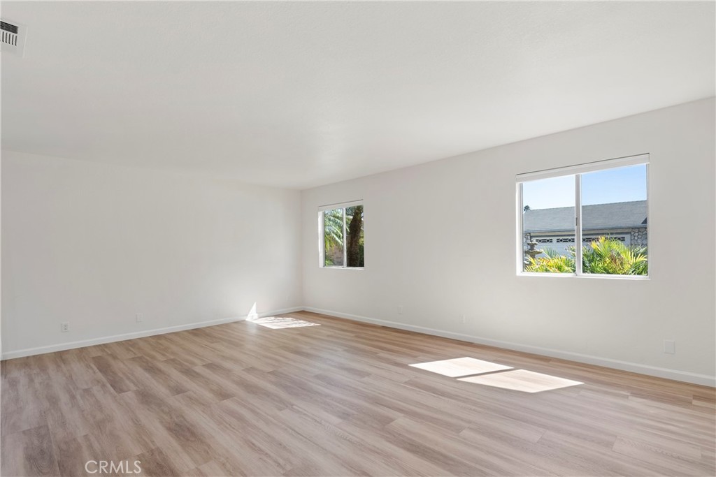700 West 2nd Street, Unit 2 Azusa, CA 91702 - Photo 7 of 39 an empty room with wooden floor and windows