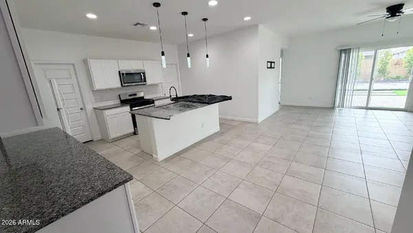 a large white kitchen with a stove a sink dishwasher and a refrigerator