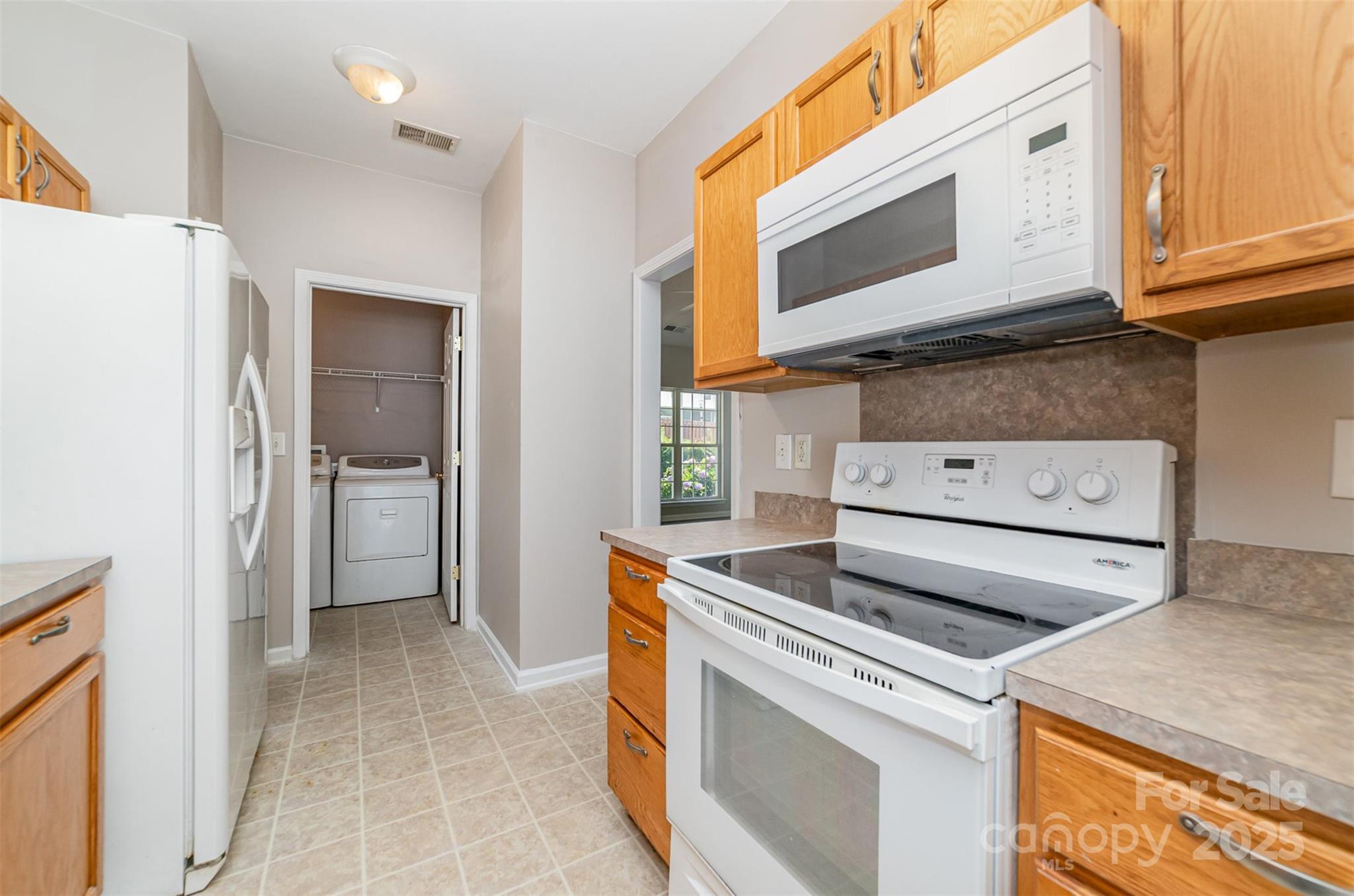 168 Devon Forest Drive Mooresville, NC 28115 - Photo 11 of 21 a kitchen with a stove and a microwave