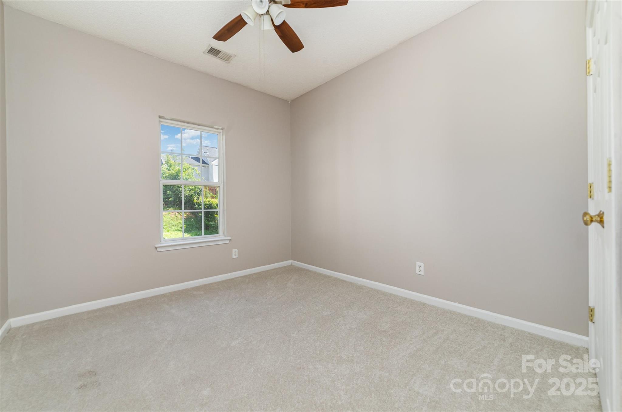 168 Devon Forest Drive Mooresville, NC 28115 - Photo 13 of 21 an empty room with a window and a ceiling fan