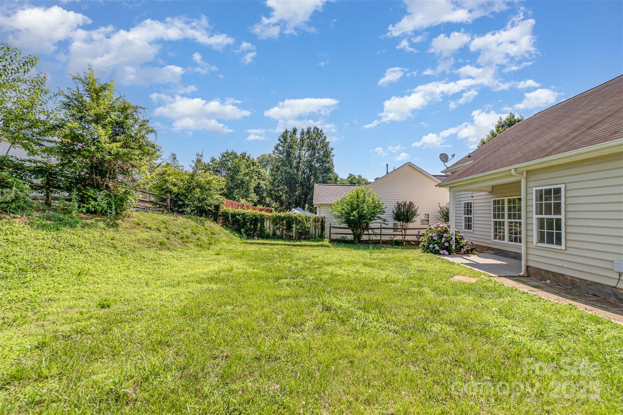 168 Devon Forest Drive Mooresville, NC 28115 - Photo 19 of 21 a view of a backyard with table and chairs and potted plants