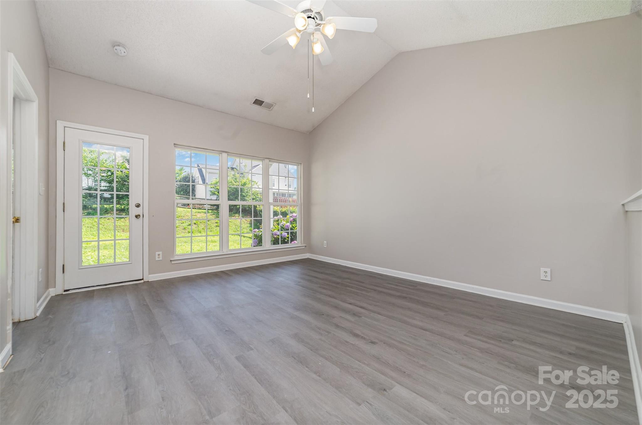 168 Devon Forest Drive Mooresville, NC 28115 - Photo 5 of 21 a view of an empty room with wooden floor and a window