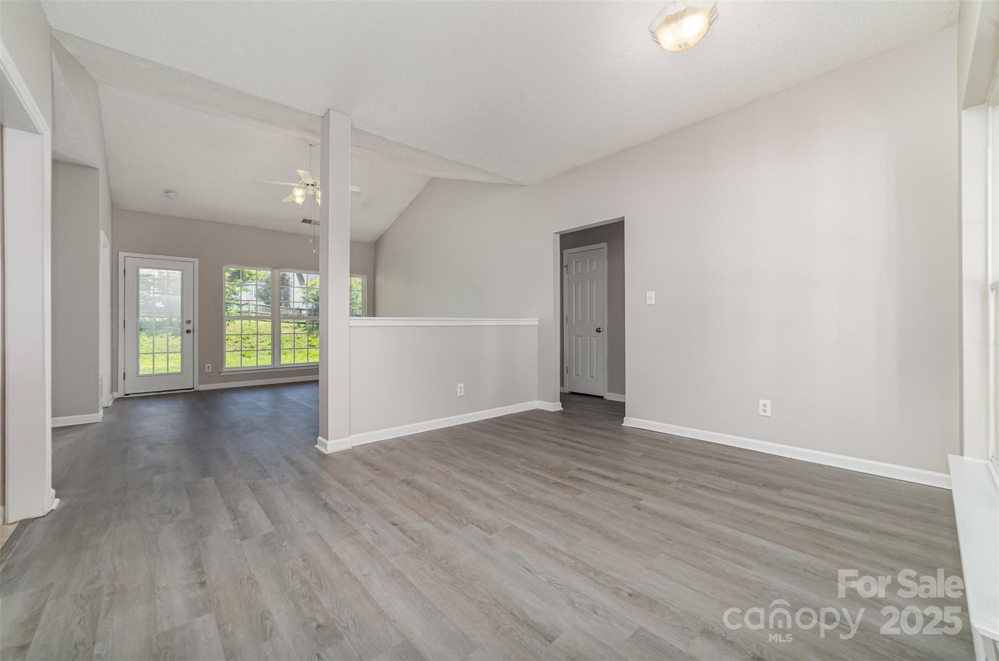 168 Devon Forest Drive Mooresville, NC 28115 - Photo 7 of 21 an empty room with wooden floor and windows