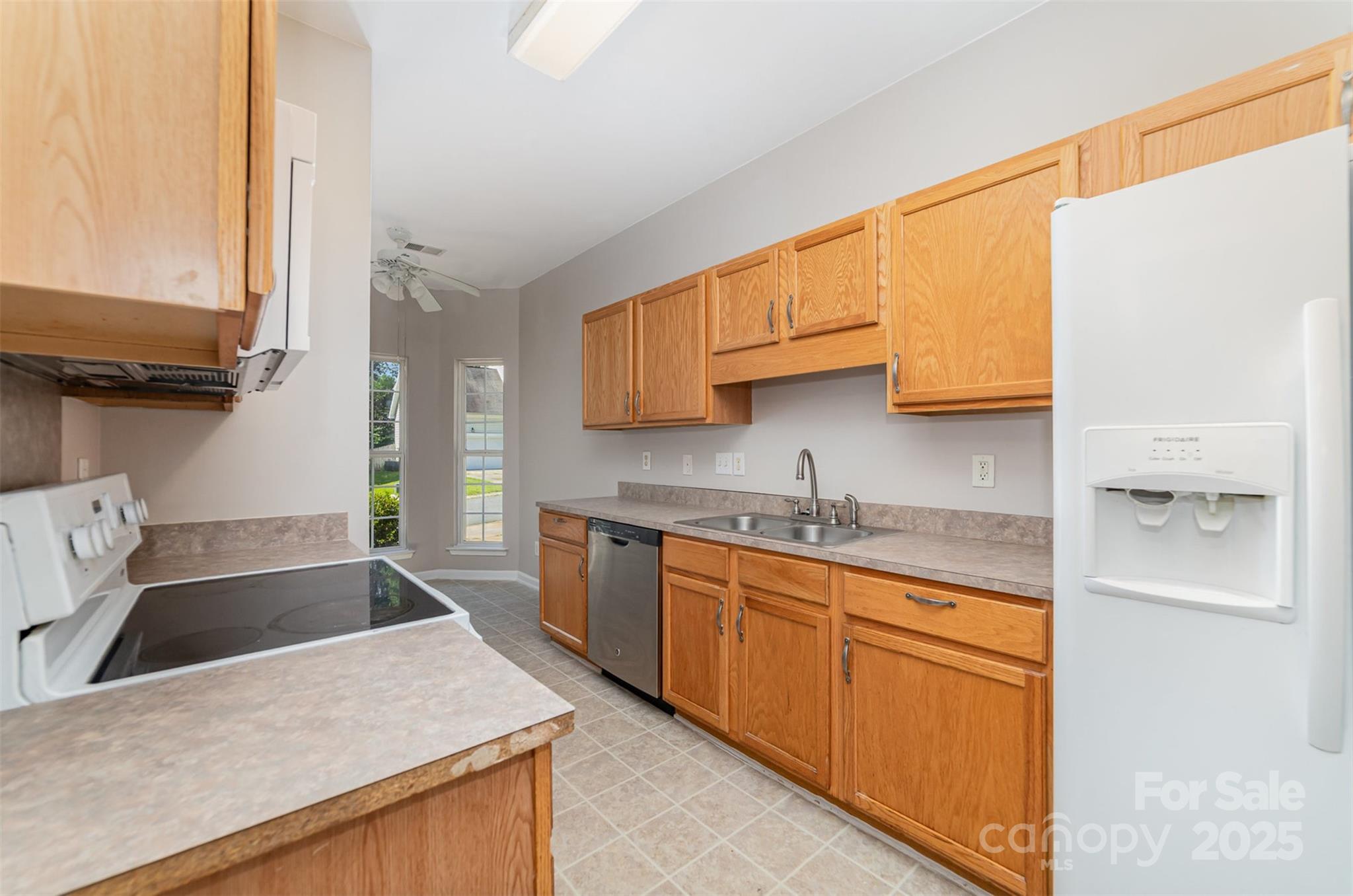 168 Devon Forest Drive Mooresville, NC 28115 - Photo 9 of 21 a kitchen with stainless steel appliances granite countertop a sink stove and refrigerator