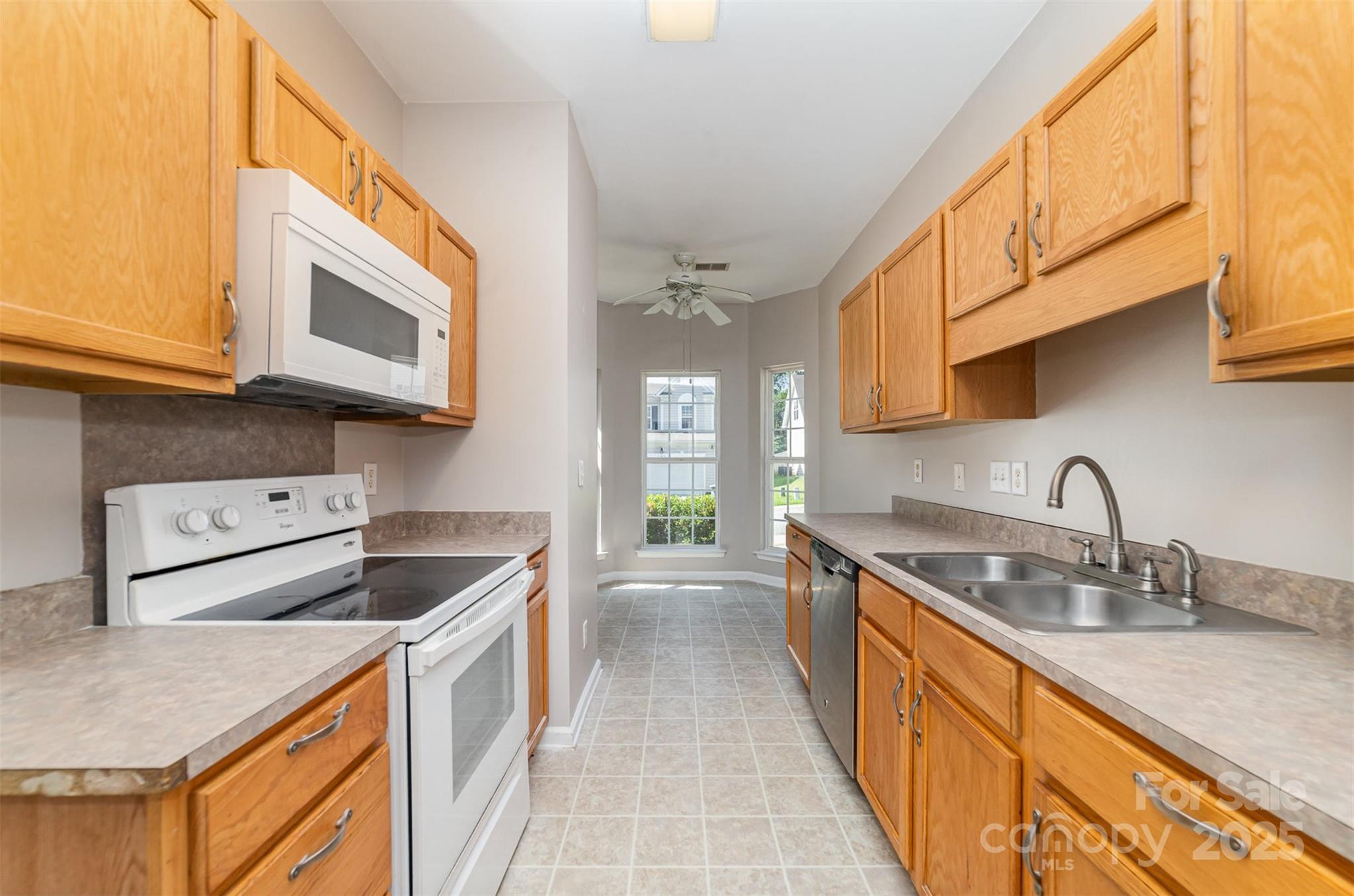 168 Devon Forest Drive Mooresville, NC 28115 - Photo 10 of 21 a kitchen with stainless steel appliances granite countertop a sink stove and cabinets