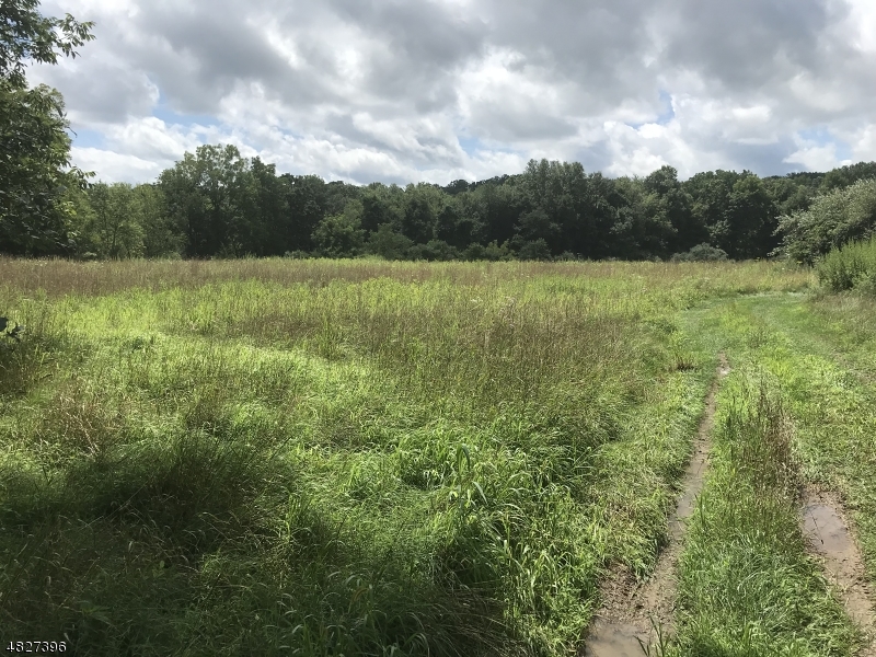 a view of a field with wooden fence