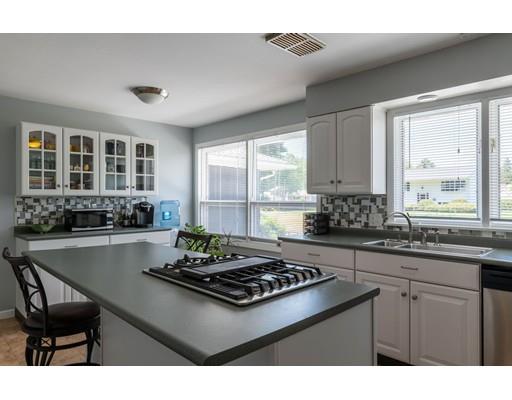 87 Hillview Road Holyoke, MA 01040 - Photo 6 of 26 a kitchen with a stove a sink dishwasher a dining table and chairs with wooden floor