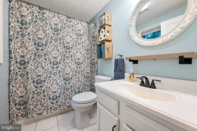 a bedroom with a bed and a mirror