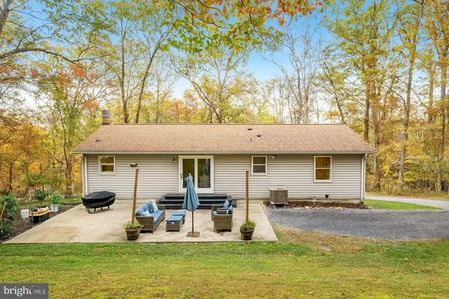 a bathroom with a granite countertop toilet sink and mirror