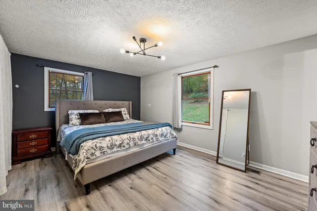 a bedroom with a bed and a table in it