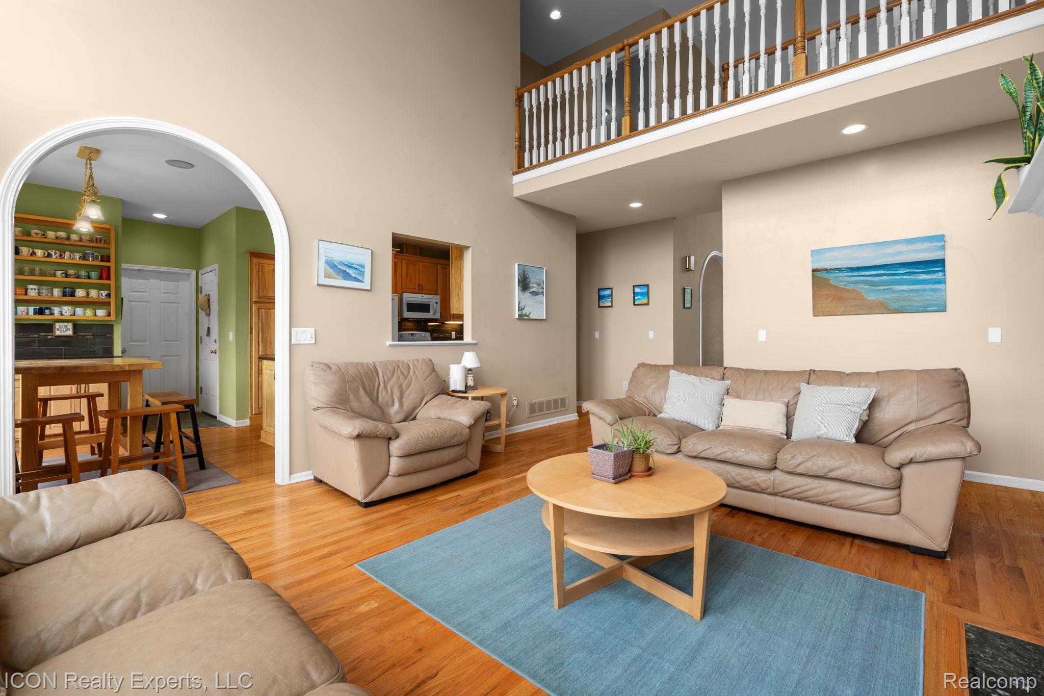 5128 Baldwin Road Metamora, MI 48455 - Photo 21 of 68 Living area featuring arched walkways, recessed lighting, light wood-type flooring, and a high ceiling