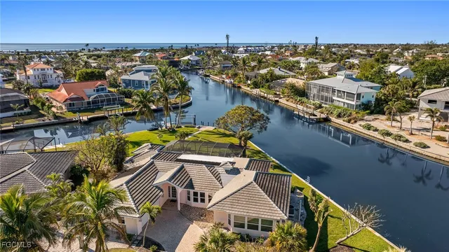 an aerial view of a house with a ocean view