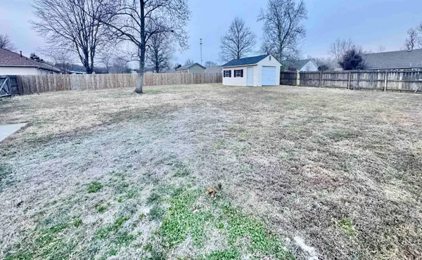 a big yard with large trees