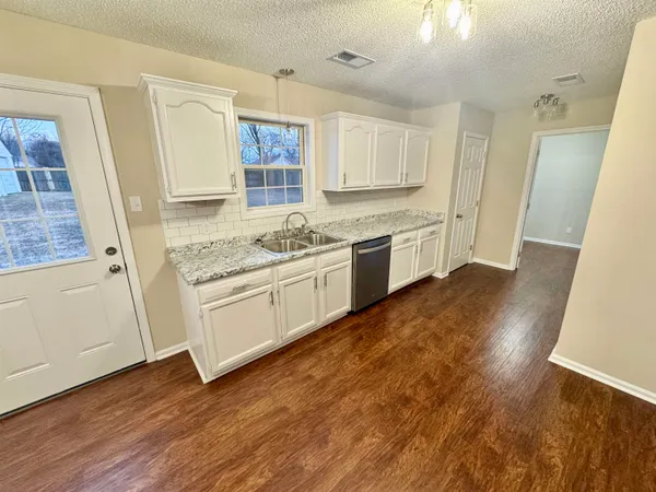 a kitchen with a stove a sink and a refrigerator