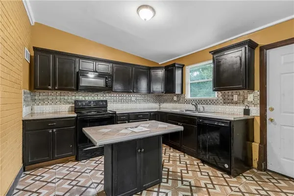 a kitchen with stainless steel appliances granite countertop a sink stove and cabinets