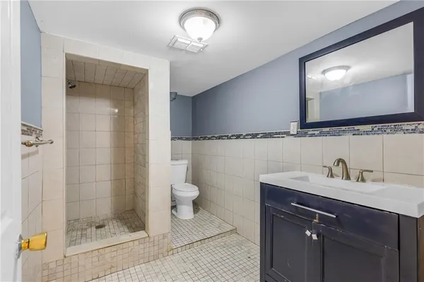 a bathroom with a sink toilet and shower