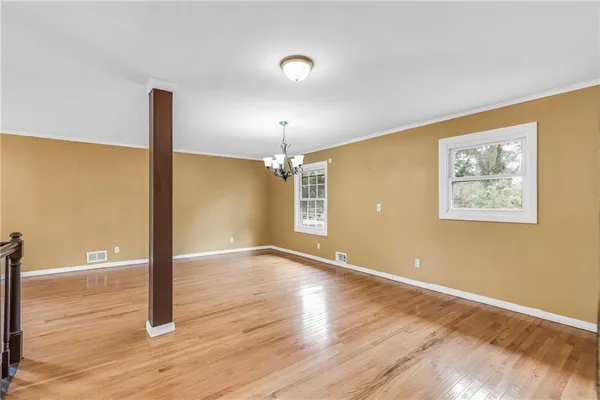 a view of a hallway with wooden floor and entryway