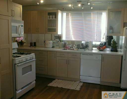356 New Market Road Dunellen, NJ 08812 - Photo 3 of 8 a kitchen with a sink stove and cabinets