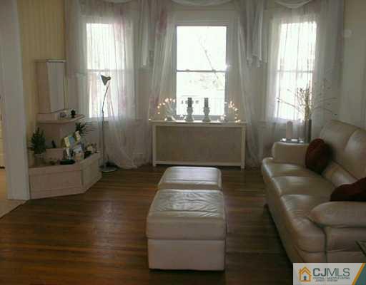 356 New Market Road Dunellen, NJ 08812 - Photo 4 of 8 a living room with furniture and a window