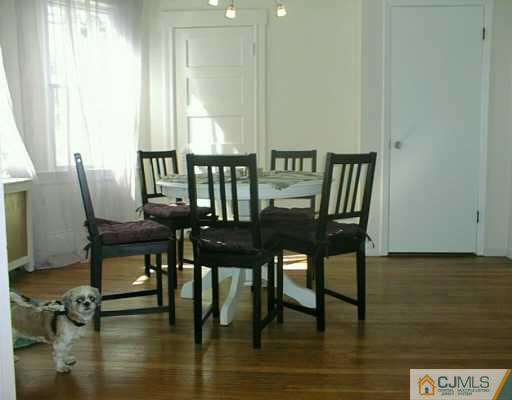 356 New Market Road Dunellen, NJ 08812 - Photo 5 of 8 a view of a dining room with furniture and wooden floor