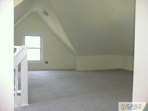 356 New Market Road Dunellen, NJ 08812 - Photo 8 of 8 a view of a livingroom with an empty space and a window