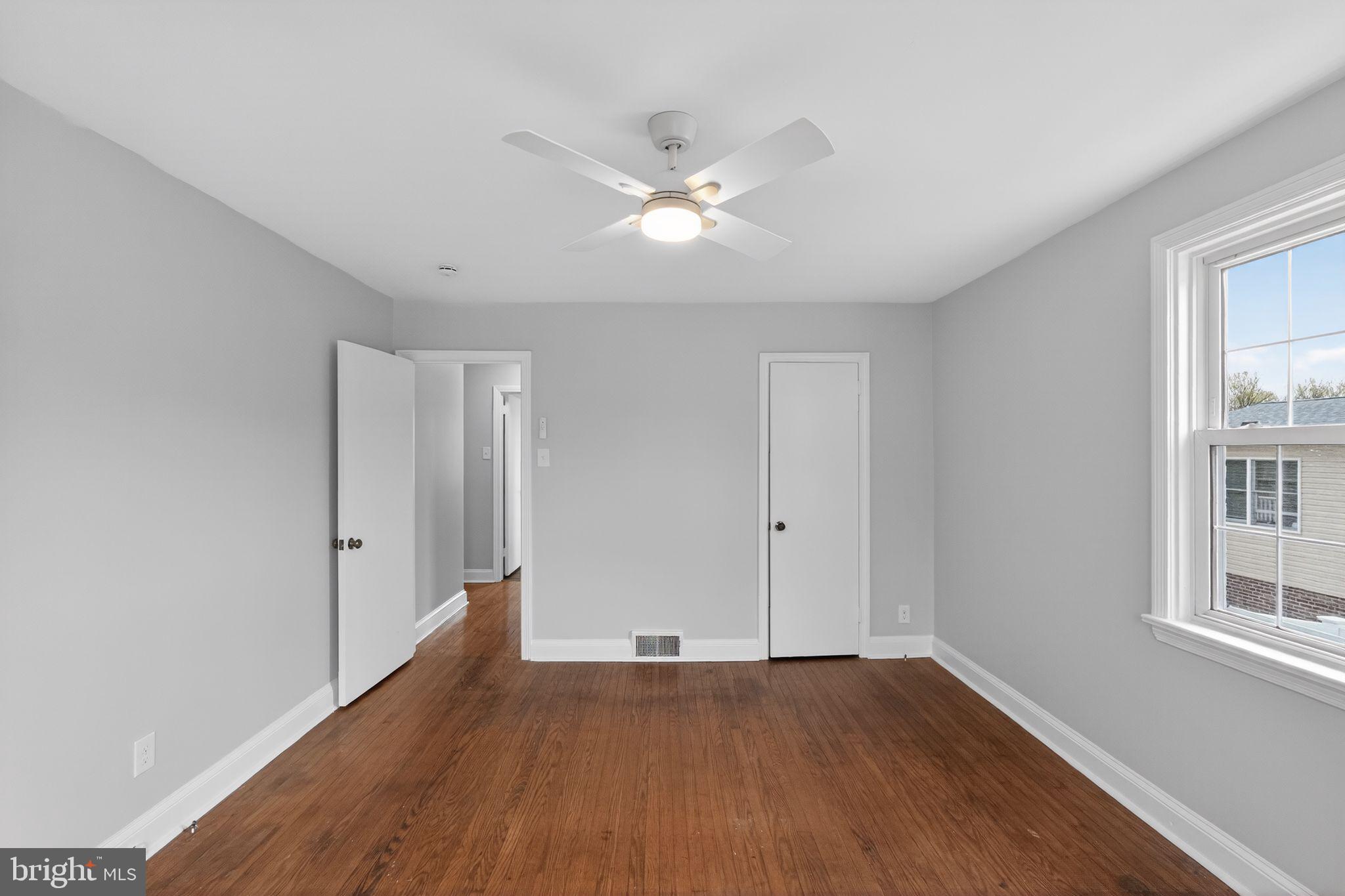 517 Weymouth Road Springfield, PA 19064 - Photo 18 of 31 a view of an empty room with wooden floor and a window