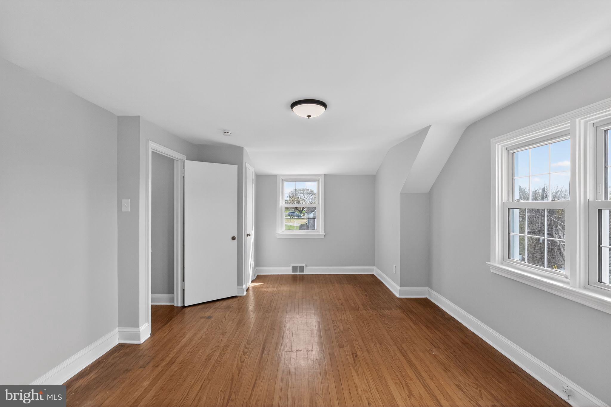 517 Weymouth Road Springfield, PA 19064 - Photo 23 of 31 a view of an empty room with wooden floor and a window